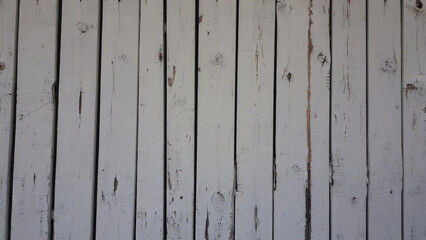 Close-up view of a worn wooden wall with flaking paint, ideal for use in historical or abandoned setting