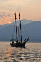 Sunset Over Mountains and Waters of Italian Lake Garda with Old Sailing Ship 