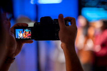 Videographer recording businesswoman giving a speech at corporate event