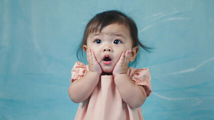 A young girl with an expression of surprise, possibly reacting to something unexpected