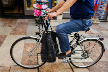 A cyclist on the street in an Italian city.