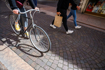 A cyclist on the street in an Italian city.