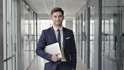 Fototapeta premium Businessman using a laptop in a formal setting