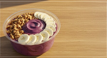 Indulge in the vibrant hues and wholesome goodness of this Acai bowl, a delightful blend of creamy acai, crunchy granola, and sweet banana slices, perfect for a healthy and refreshing treat.