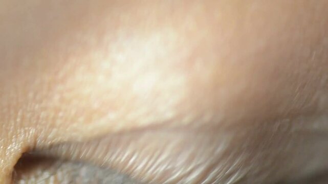 Blue Eye of girl looking at Camera Close Up. Macro Shot front view Opening and Closing Blue Eyes Little Girl Close Up Motion of famele Eyes background