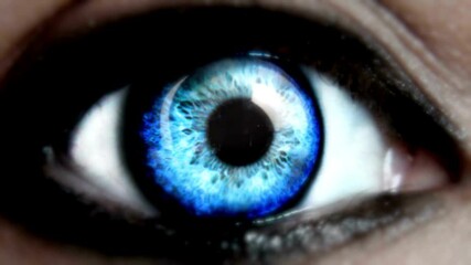 Blue eye opening widely. Macro close-up. Slow motion. opening human iris beautiful blue eye healthy eyesight awareness concept Shot on Cinema Camera.