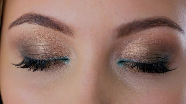 Extra macro shot opening eye with blue iris and big pupil resizing when exposed to light. Healthy eyesight and vision problems Slow motion background