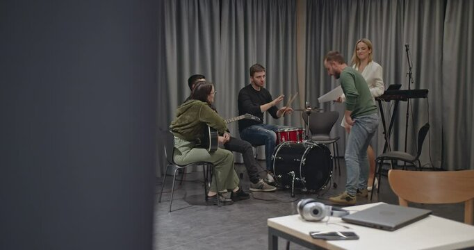 Band practice session before a concert. Musicians prepare, fine-tune, and rehearse their music in a studio setting.