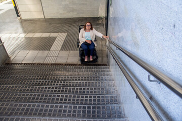 Businesswoman in wheelchair facing accessibility issues in subway station. Concept of inclusion