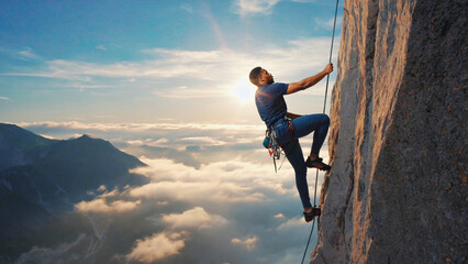 A person climbing up the rocky side of a mountain, great for outdoor adventure and travel concepts