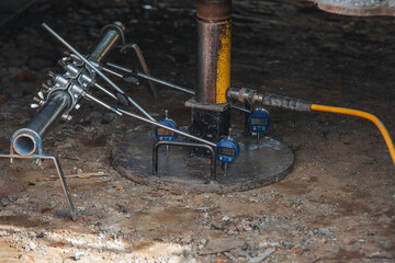 Geotechnical technician using gauges to perform California Bearing Ratio (CBR) test of the ground...