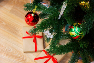 Close-up of New Year's gifts. Christmas tree in the background. New Year. Christmas. Gifts.