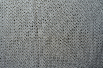 Surface of ivory white handmade crochet lacy fabric