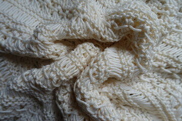 Crumpled light beige handmade crochet lacy fabric