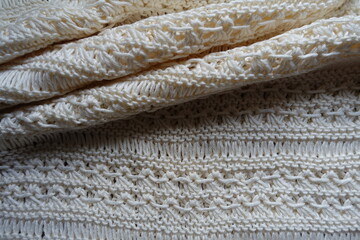 Folded light beige handmade crochet lacy fabric