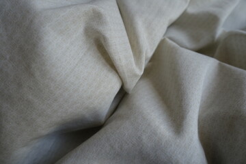 Crumpled pale beige cotton fabric with circles pattern