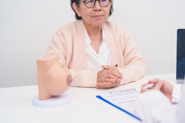 Elderly woman Patient consultation with doctor for Breast Augmentation Surgery, October Breast...