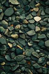 Close-up view of a textured surface of various-sized, dark-colored stones