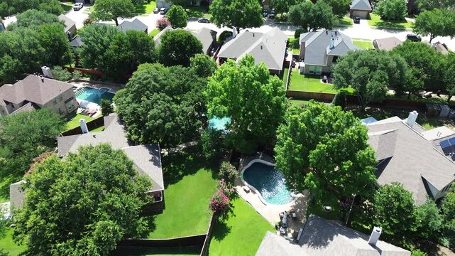 Lush green homes mature trees, rooftop solar panel arrays, angled installations for optimal sunlight capture, supporting clean efficiency energy, lower bills, sustainable, DFW metroplex, Texas