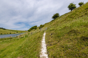 Looking along a chalk pathway running alongside farmland in Sussex