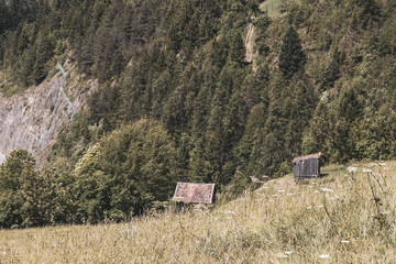 Austria alpine mountain landscape farm panorama with little hut huts.