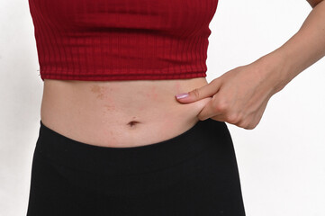 Young woman captures excess fat on her belly.