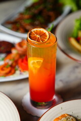 glass of orange juice and fresh fruits