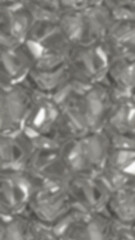 Abstract blurred surface displays multiple rounded shiny shapes creating a textured grey and white background