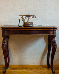Antique case phone with disk dial on an antique Lambert desk