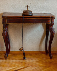 Antique case phone with disk dial on an antique Lambert desk