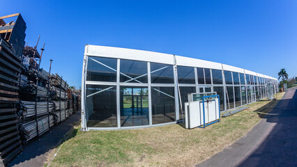 Large portable canvas tent structures with clear plastic perspex walls.