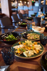 A gourmet dish with bread and fresh, flavorful ingredients elegantly arranged on a plate