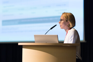 Female speaker giving a talk on corporate business conference. Business and Entrepreneurship event