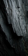 Dark Textured Surface of Natural Stone with Vertical Lines and Layers