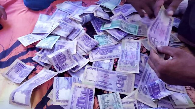 Bangladesh Currency Banknotes. People touching money with hands. man counting Bangladesh money and counting Bangladeshi 1000 taka banknotes.