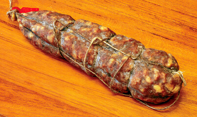 Seasoned salami resting on a cutting board