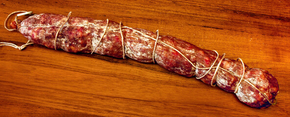 Cured Sausage Resting on Wooden Cutting Board
