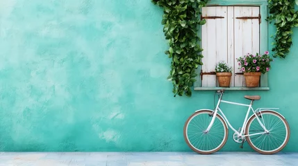 Fototapete A beautifully styled turquoise wall adorned with a vintage bicycle and lush greenery, creating a warm, inviting atmosphere perfect for a quaint outdoor setting. © Larisa AI