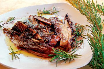 Radicchio trevisano seasoned with rosemary and olive oil on white plate