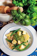 Trenette pasta with pesto, potatoes and green beans enriching a dish with Italian flavors