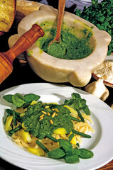 Chef preparing trofie pasta with pesto sauce, potatoes and green beans