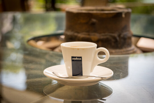 Lavazza Espresso coffee cup on a glass table