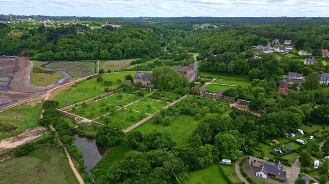 Approaching drone movement to the gothic Abbaye de Beauport historical abbey on beautiful parklands and well-groomed gardens, Paimpol, Brittany, France.