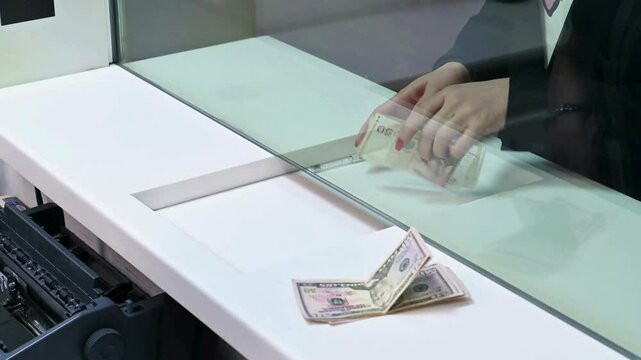 Bank teller counting paper money. Automatic mechanism for bank financial operations. close-up of hands meticulously counting hundred dollars bills. Exchange finance economy dollar money.
