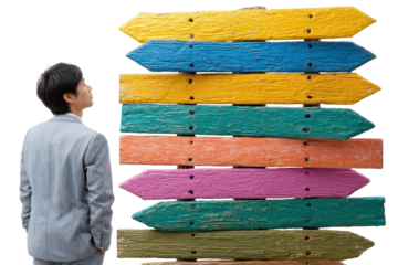 Individual in Suit Contemplating Colorful Directional Signs with Various Shades and Textures Against White Background
