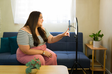 Plus size influencer creating content at home with ring light