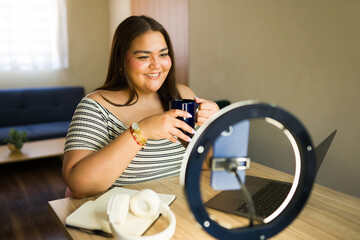 Plus size influencer creating content with a ring light and smartphone