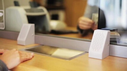 Employee and client count US dollar money on a counter at the currency exchange office. hands counting money in cash department window. business worker's hands counting dollar banknotes at the office. - Powered by Adobe