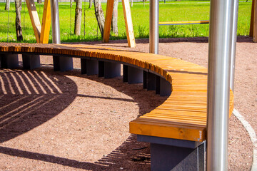 Wooden modern bench in the park. Landscape design