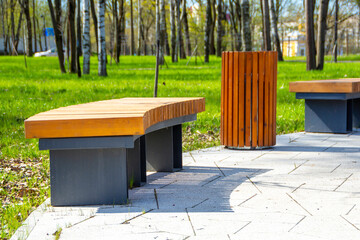 Wooden modern bench in the park. Landscape design
